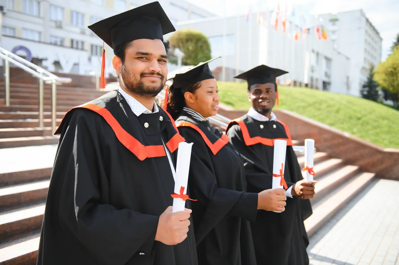 Graduates holding their certificates