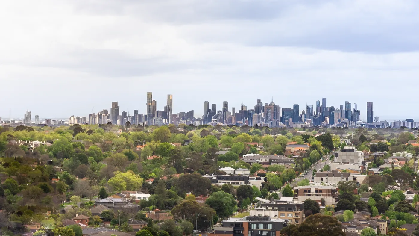 Melbourne skyline above green suburbs