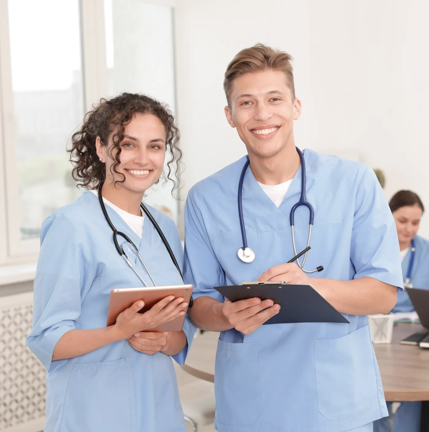 Two healthcare professionals preparing for OET